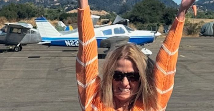 Karen at a private airport facing my fears by skydiving